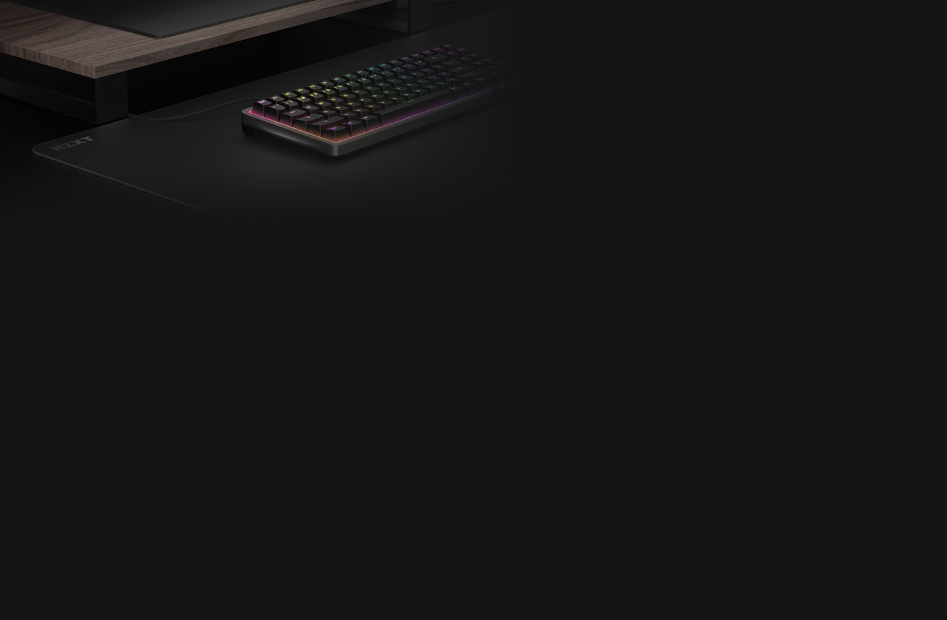 Zone Elite Mousepad sitting on a desk with a keyboard. Dark background.